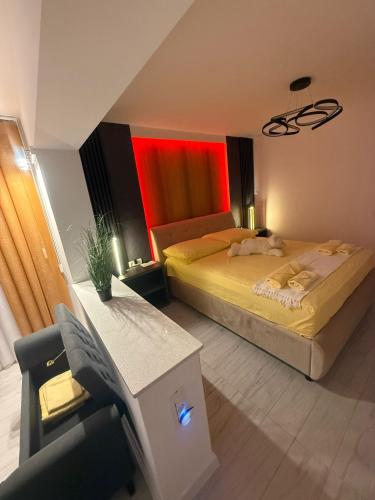 a bedroom with two beds and a chair in it at Krisman Residence 3 in Piteşti
