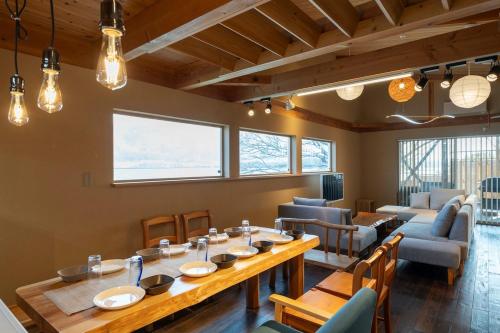 a dining room with a long table and chairs at Dannoura Resort Villa in Takamatsu