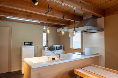 a kitchen with a sink and a counter top at Dannoura Resort Villa in Takamatsu