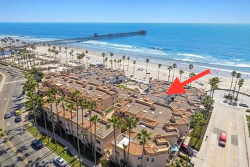 a house on the beach with a red arrow at 5N-31 Beach View BBQ & Jacuzzi in Oceanside