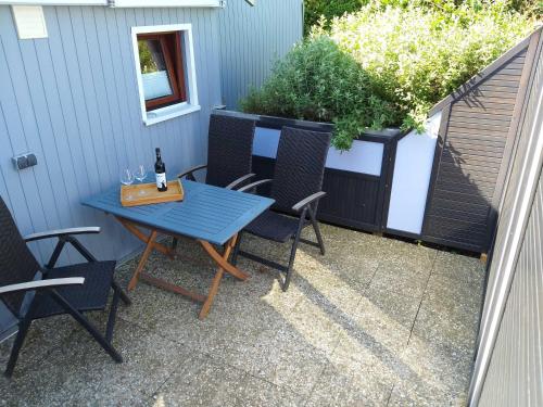 a blue table and chairs on a patio at Ferienhaus Ostwaldt - zwischen Stralsund und Greifswald in Kirchdorf