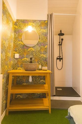 a bathroom with a sink and a wall at Escapade Secrète in Obernai