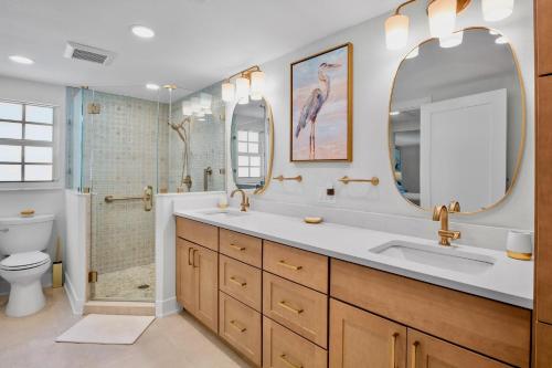 a bathroom with a sink and a shower and a toilet at Lavender Lagoon in Anna Maria