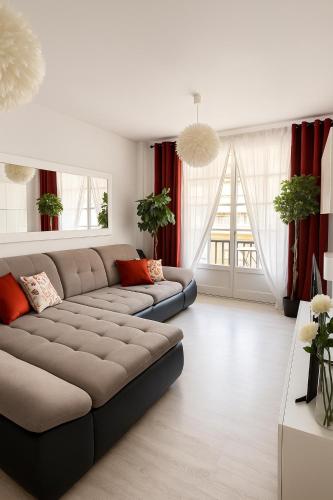 a living room with a couch and red curtains at Fairytale in Adeje in Adeje