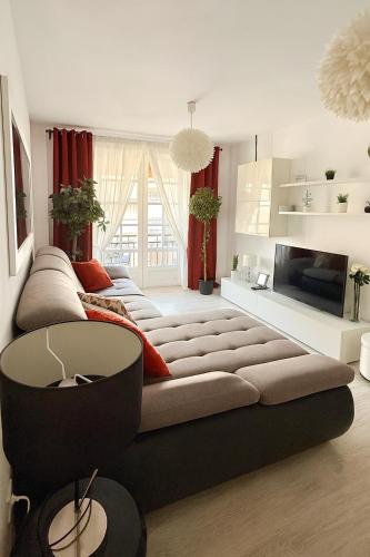 a living room with a large couch and a tv at Fairytale in Adeje in Adeje