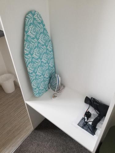 a tie sitting on top of a white shelf at TLK Apartments & Hotel - Beckenham Junction in London