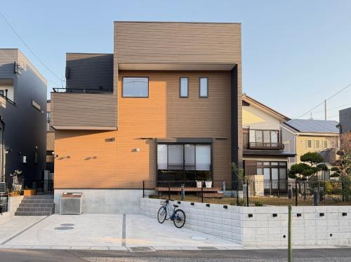 a building with a bike parked in front of it at The YAMAGUCHI山口Golf Residence in Inzai