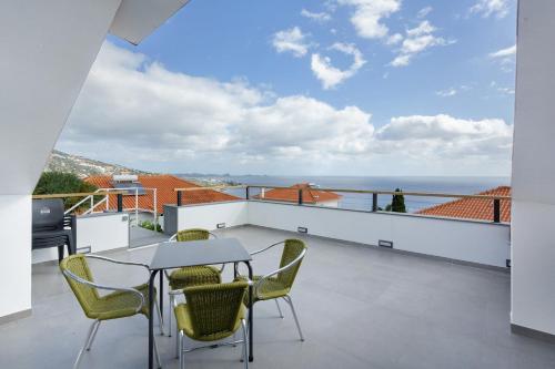 a balcony with a table and chairs and the ocean at Sky and Sea Haven in Santa Cruz