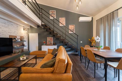 a living room with a couch and a table at 3 MURA rooms in Teulada