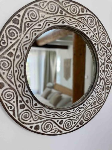 a mirror is hanging on a wall at Texel Atelier in De Koog