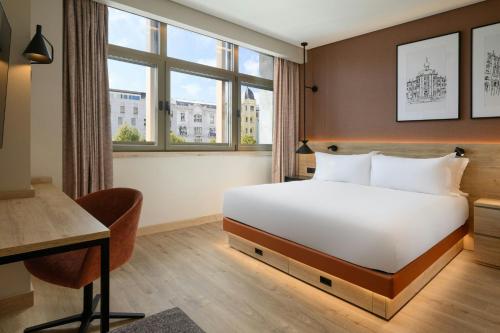 a hotel room with a bed and a desk at Residence Inn by Marriott Lisbon in Lisbon