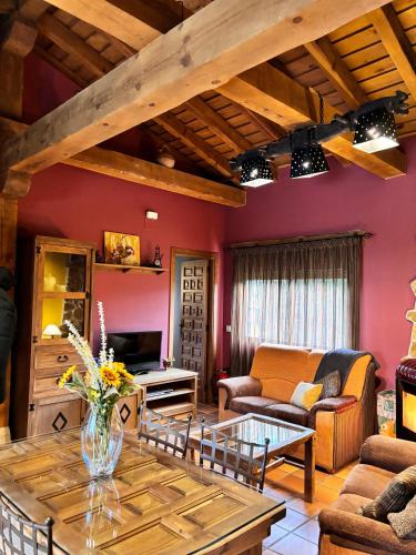 a living room with a couch and a table at Casa Rural El Regajo in Tenzuela