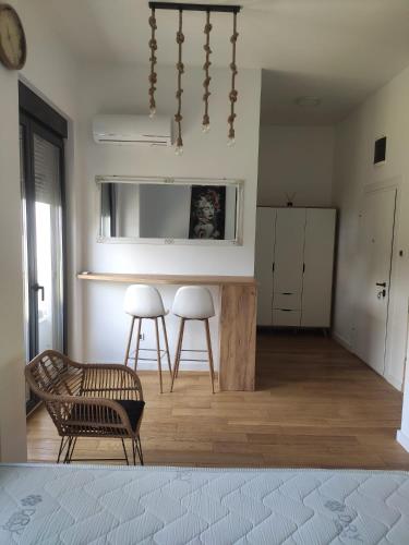 a living room with a table and two stools at Xenia in Petrovaradin