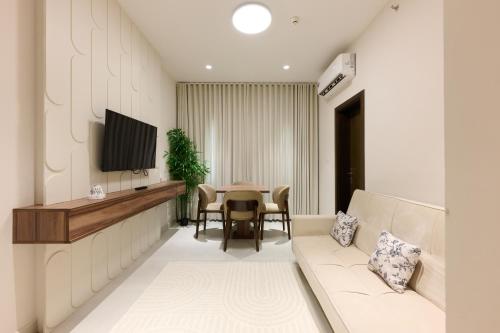 a living room with a couch and a table at Khorfakan by the Living in Khor Fakkan