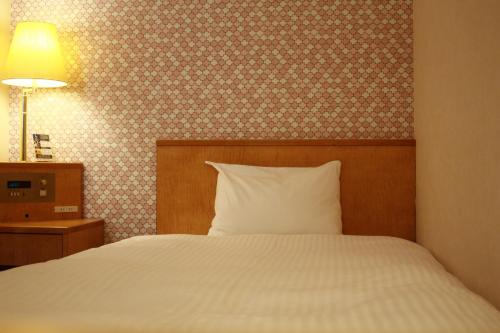 Ένα ή περισσότερα κρεβάτια σε δωμάτιο στο Hotel Premium Green Sovereign