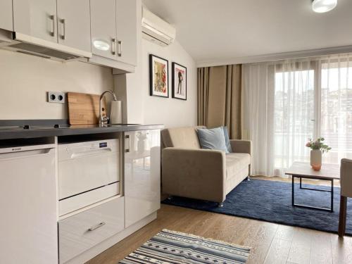 a kitchen and living room with a couch and a table at Elmoria Pera In Hotel in Istanbul