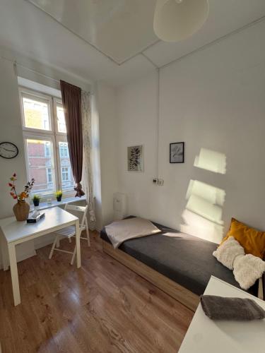 Ένα ή περισσότερα κρεβάτια σε δωμάτιο στο Pokoje przy Rynku I