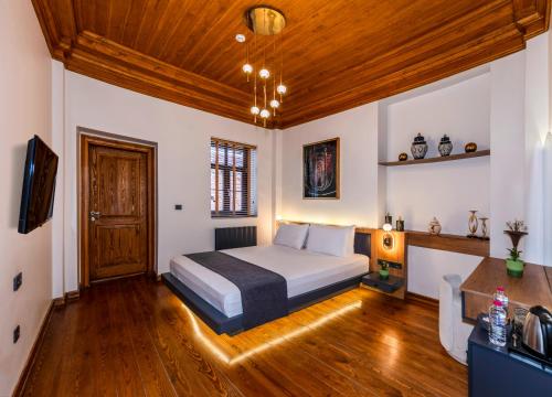 a bedroom with a bed and a wooden ceiling at Elmoria Pera In Hotel in Istanbul