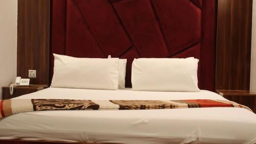 DargaiにあるHotel Comfort Innの大型ベッド(赤いヘッドボード、白い枕付)