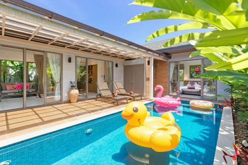 a pool with inflatable rubber ducks in a house at Private Resort Boutique Pool Villa Dalaa 5 , near Kamala Beach in Kamala Beach