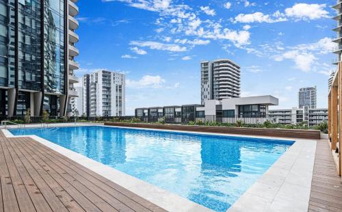 a large swimming pool on a building with tall buildings at Brand New Waterview family residence 3 bedrooms -Pool, Parking in Sydney