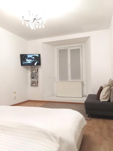 ein Schlafzimmer mit einem Bett und einem Fernseher an der Wand in der Unterkunft Maison 29 in Braşov