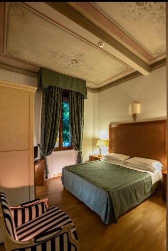 a bedroom with a large bed and a window at Relais Le Felci Executive Suite Spa in Fiuggi