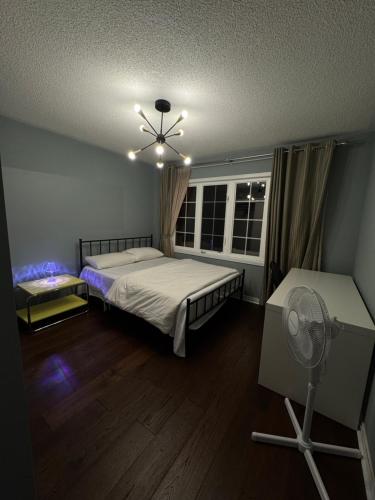 a bedroom with a bed and a ceiling fan at Gorgeous Private room in Toronto