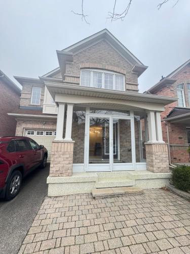 a red car parked in front of a house at Gorgeous Private room in Toronto