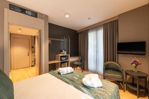 a hotel room with a bed with two towels at QUİ Hotel&SPA in Istanbul