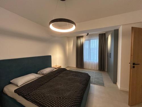 a bedroom with a large bed in a room at C&E Apart in Craiova