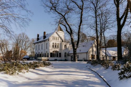 ein großes weißes Haus im Schnee in der Unterkunft Landgoed Frymerson in Sint Odiliënberg