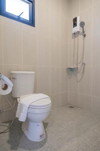 a bathroom with a toilet and a shower at Uncle Toy in Ban Riang