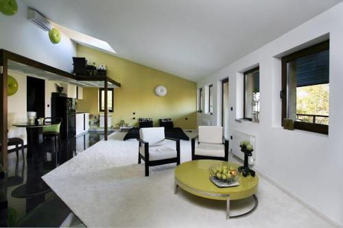 a living room with a yellow table and chairs at Vila 6aTo Hotel & Wellnes in Sofia