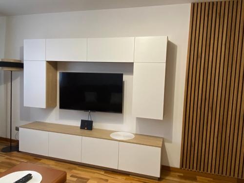 a large white entertainment center with a flat screen tv at Apartament Wysoka Brama in Lidzbark Warmiński