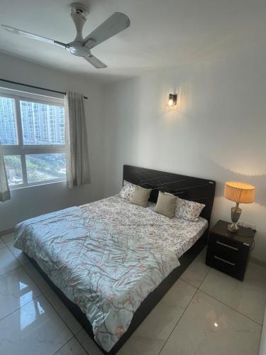 a bedroom with a bed and a ceiling fan at Vaibhav Stays in Nalmatha