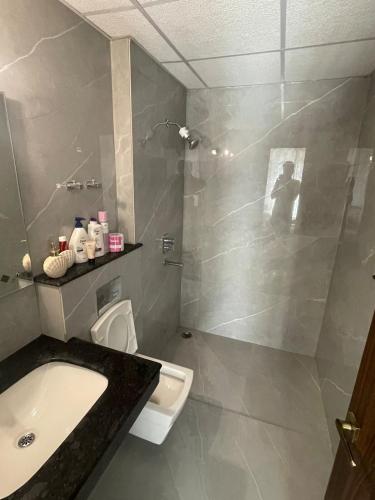a bathroom with a shower and a sink and a toilet at Vaibhav Stays in Nalmatha