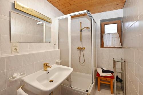 a white bathroom with a sink and a shower at Rundblick 3 Panorama Klein in Tschagguns