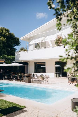 a villa with a swimming pool and a house at Domìa Boutique Hotel e Cucina in Mondello