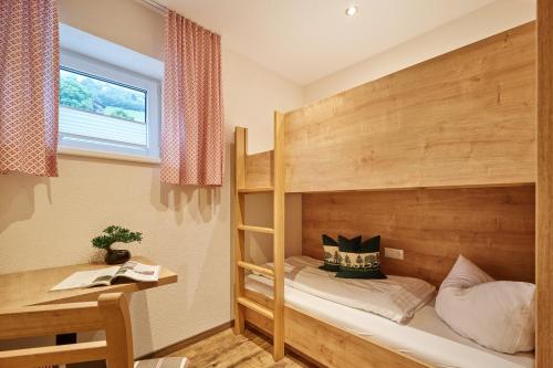 a bedroom with a bunk bed and a window at Pitztal Living Apartments in Jerzens