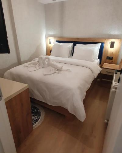 a bedroom with a bed with two swans on it at BOLCELLO HOTEl in Istanbul