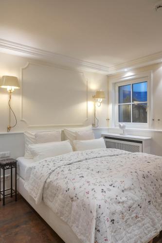a white bedroom with a large bed and a window at Heefwai 2 W2 in Morsum