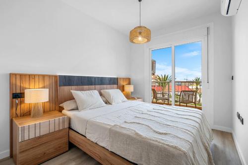 a bedroom with a large bed and a balcony at Piso Maria in San Miguel de Salinas