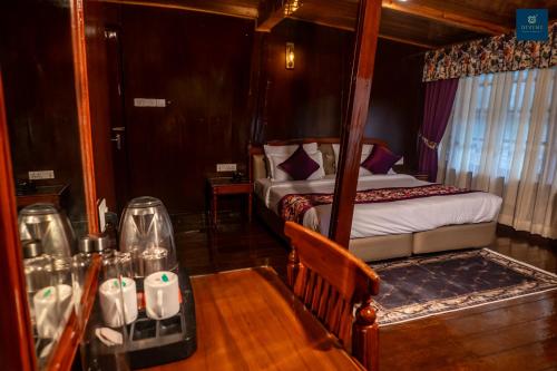 Ένα ή περισσότερα κρεβάτια σε δωμάτιο στο Divine Himalayan Resort, Darjeeling