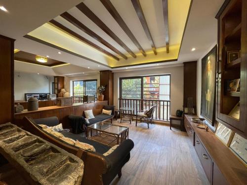 a living room with a couch and a table at Ambassador Garden Home in Kathmandu