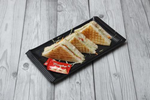 PrayagrajにあるHotel Sangam Viewのサンドイッチとスナックが載った黒い皿