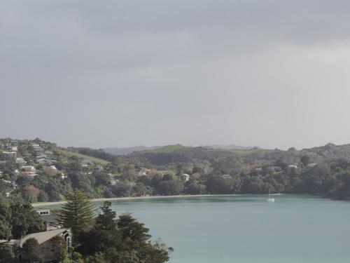 a view of a lake with houses and trees at Waiheke Island Tawa Lodge - Adults Only in Oneroa