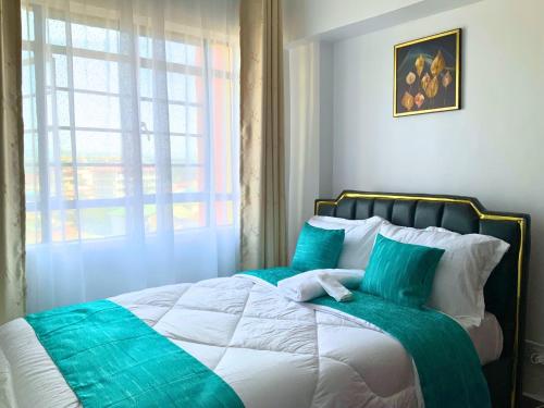 Postel nebo postele na pokoji v ubytování Inka Residency Kisumu