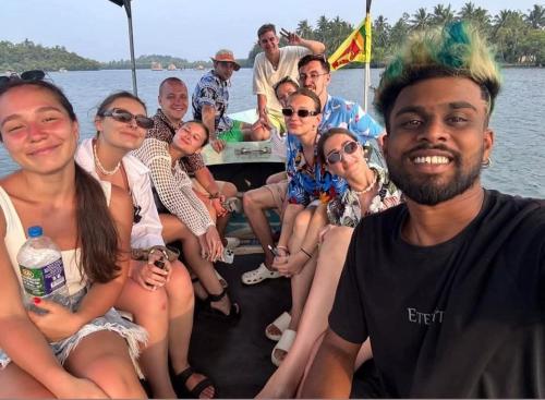 a group of people sitting on a boat at Baba Place Thalpe in Galle