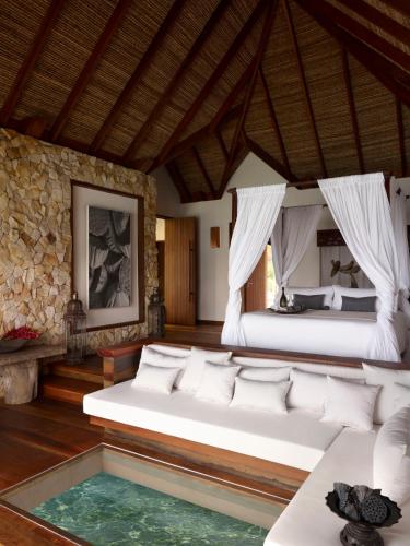 a bedroom with two beds and a swimming pool at Song Saa Private Island in Song Saa Private Island